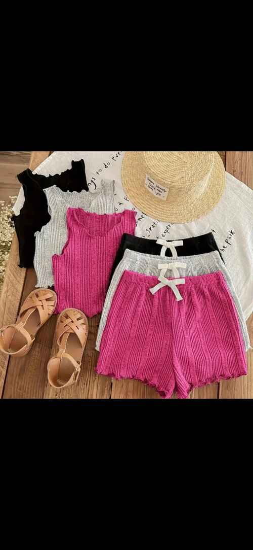 6-Piece Baby and Toddler Clothing Set featuring colorful onesies, soft pants, cozy socks, and accessories like a bib, towel, and blanket placed on a rustic wooden surface.