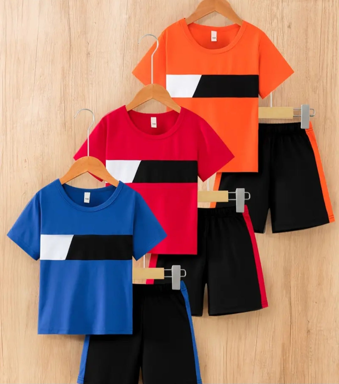 Donabebe 6-Piece Boys' Spring/Summer Casual T-Shirt and Shorts Set featuring a colorblock design, includes T-shirts in blue, red, and orange, paired with black shorts, perfect for warm-weather adventures.
