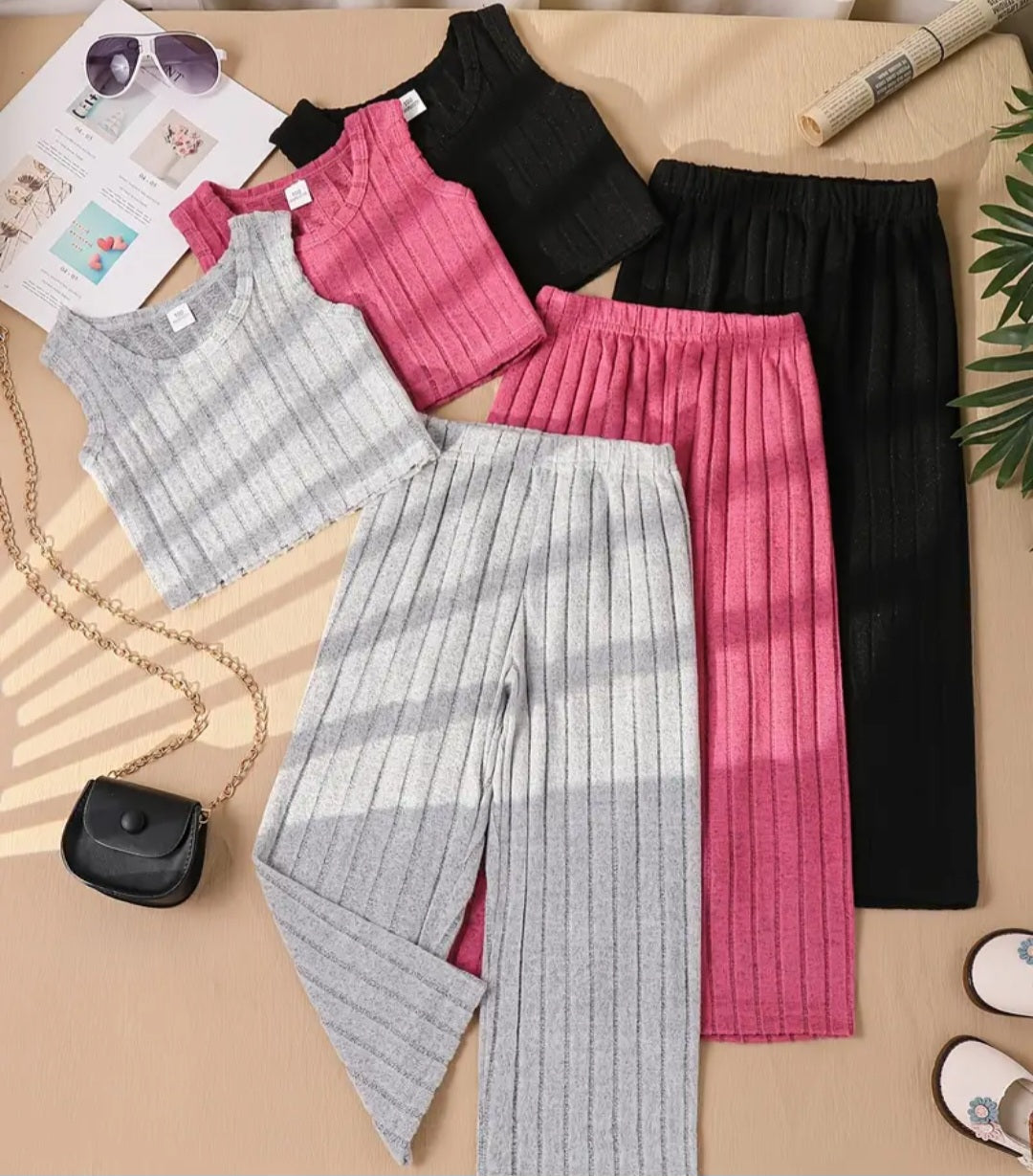 6-Piece Girls Ribbed Tank Top & Pants Set featuring a variety of colors including gray, pink, and black, arranged stylishly on a table, perfect for summer fun.
