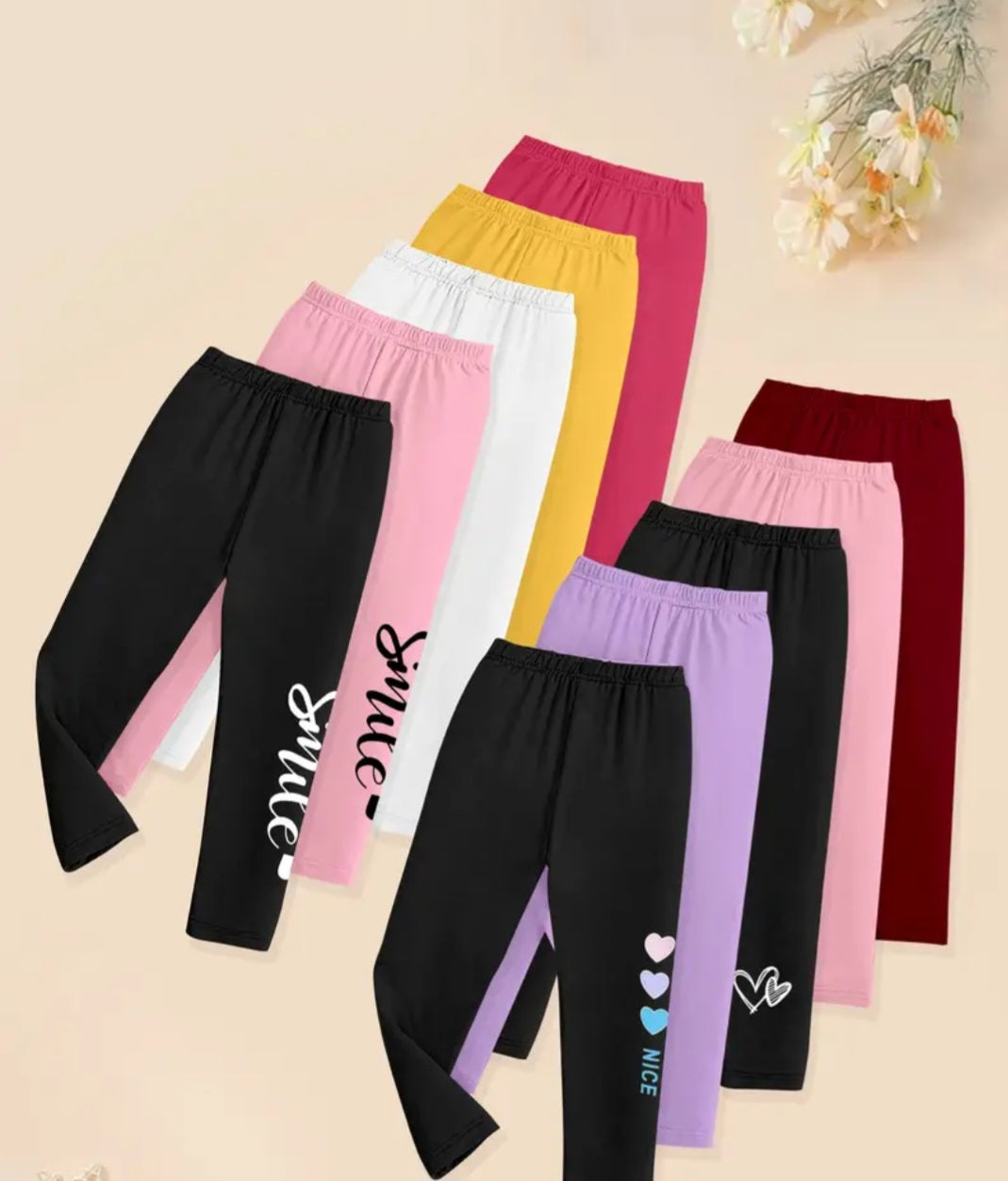 10 Pcs Girls Leggings Set featuring colorful heart and letter prints, showcasing a variety of comfortable leggings in vibrant colors like pink, purple, and black, perfect for young fashionistas. Made from a soft polyester blend, these stylish leggings are ideal for everyday wear.