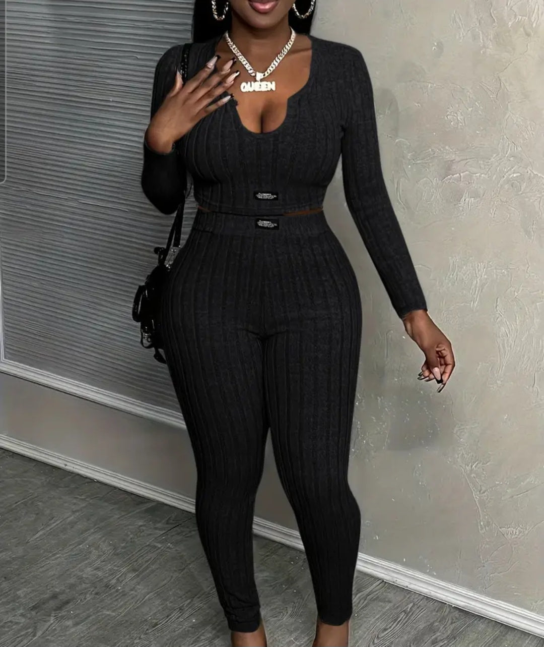 Women's Slim-Fit Long Sleeve Top & High-Waist Pants Set in black, featuring a sleek slim-fit design with a stylish long sleeve top and high-waist pants, set in a chic environment.