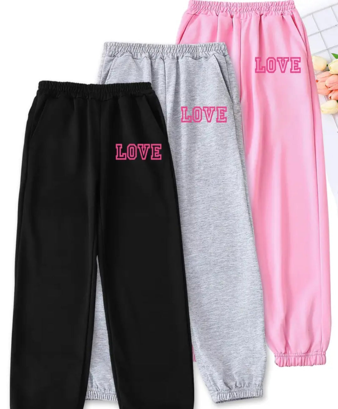 Girls 3-Piece Love Print Jogger Pants Set featuring black, grey, and pink jogger pants with 'LOVE' print, ideal for casual and stylish everyday wear.