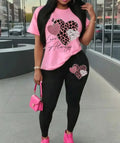 Women's Love Always Outfit in pink, featuring a chic bohemian top with a heart print and matching black leggings, perfect for casual outings.
