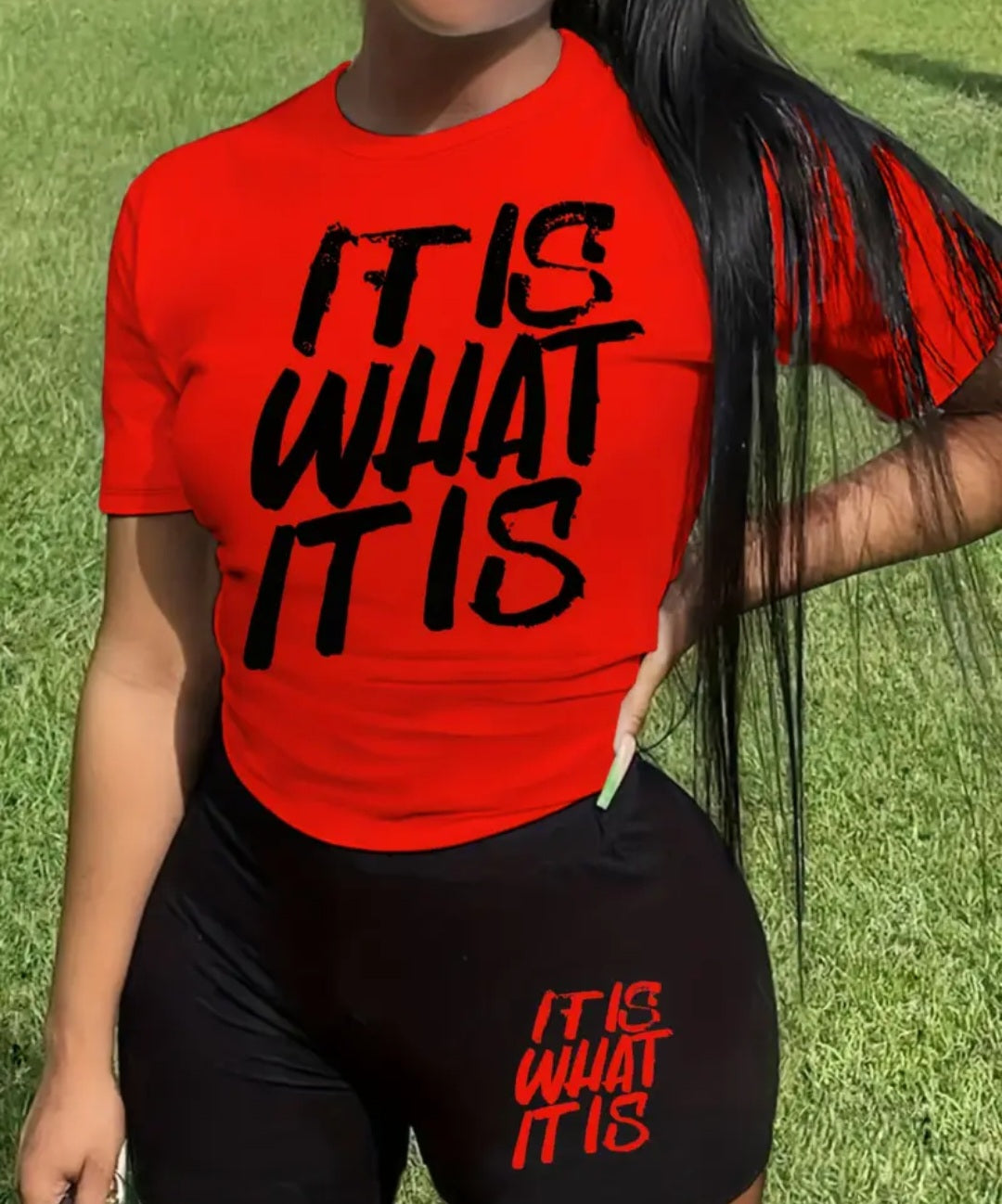 Women's Casual 'It Is What It Is' Lounge Set in red, showcasing a comfortable relaxed-fit top with bold black lettering and stylish black bottoms. Ideal for everyday wear.