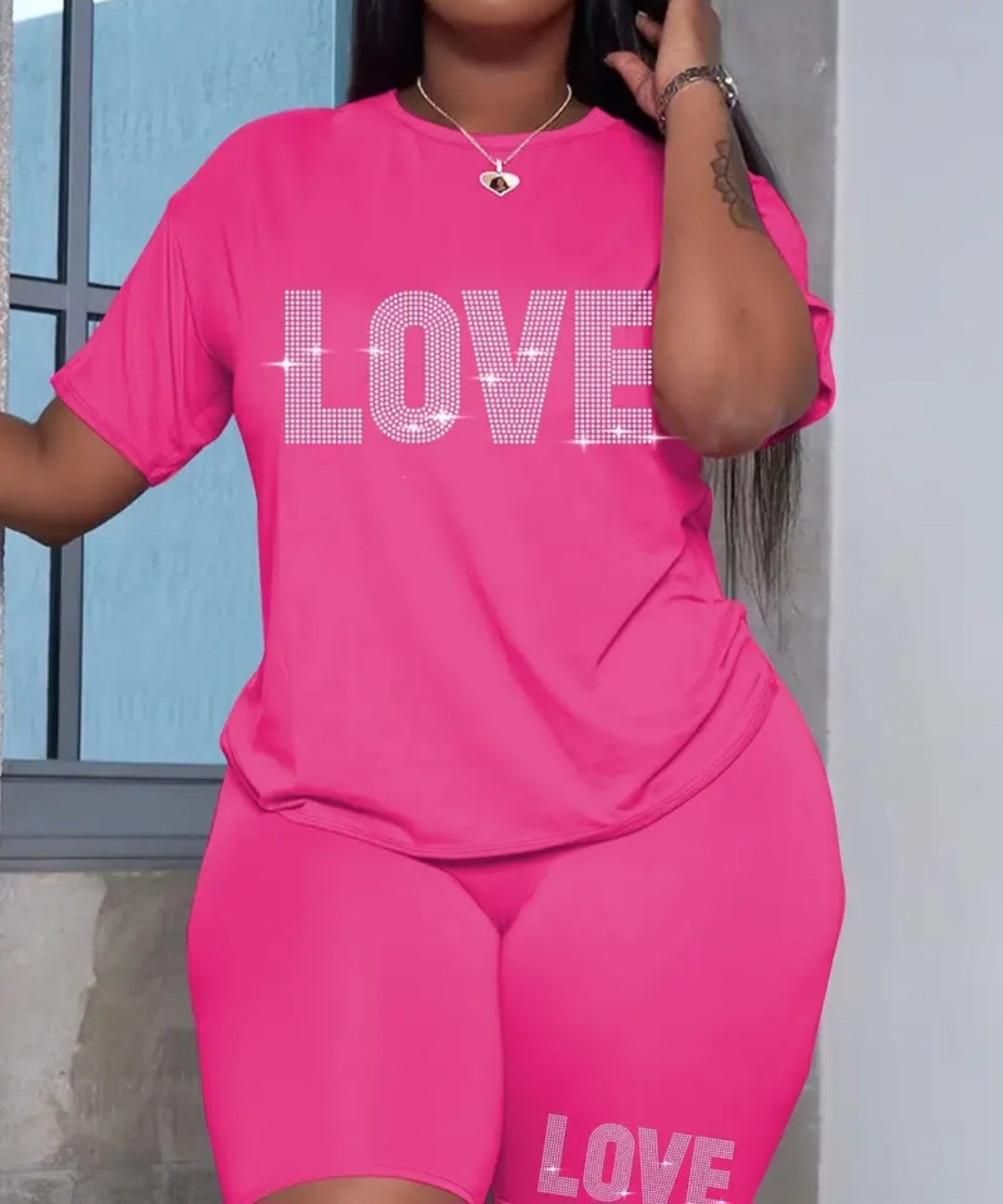 Plus Size Women's Love Set in pink showcasing a casual outfit with a t-shirt adorned with 'LOVE' print and complementary shorts, perfect for a fun and fashionable look.